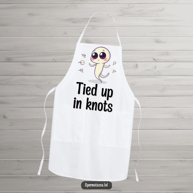 Funny sperm cell apron showing a googly-eyed sperm cell juggling tiny sperm cells with its tail, for humorous kitchen use.
